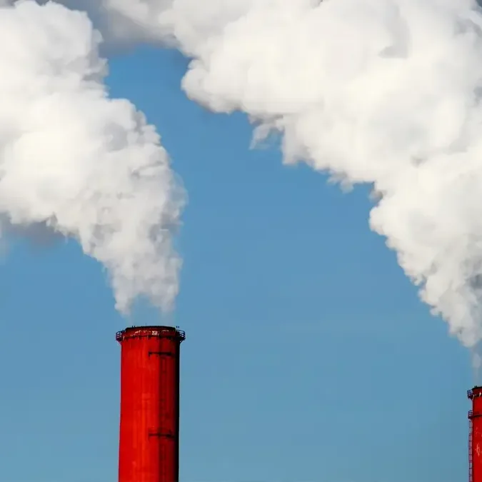 Industrial smoke stacks billowing smoke