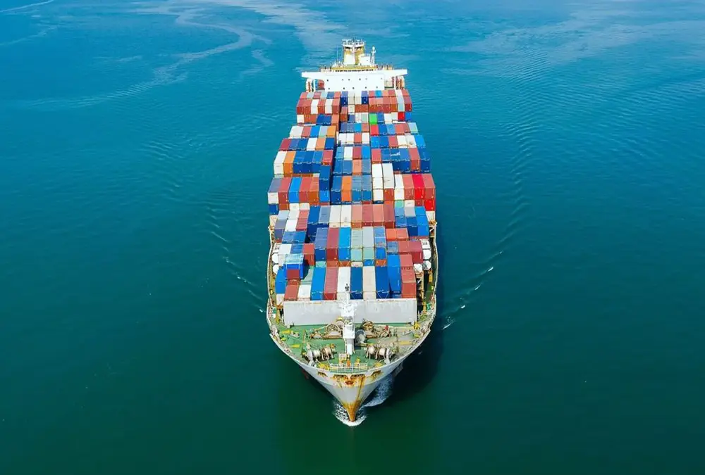 Cargo ship with containers sailing on water