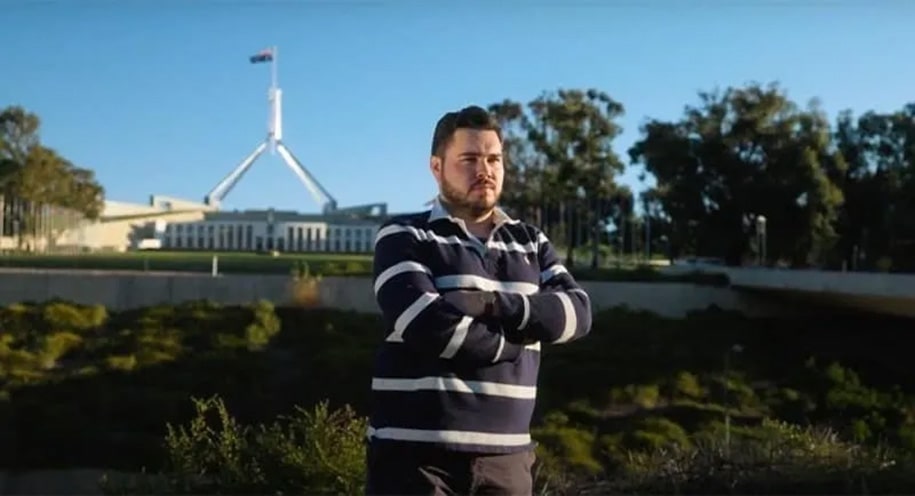 Bruce Lehrmann standing in front of parliament house
