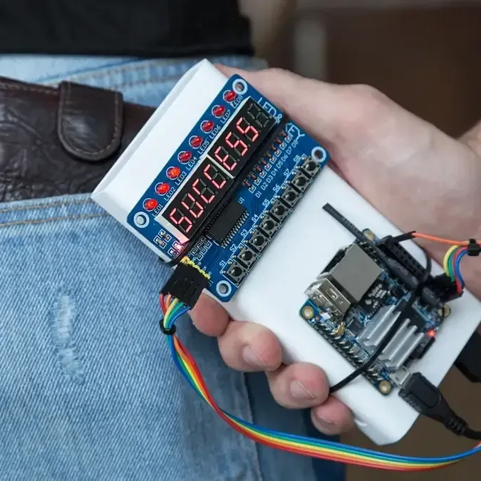 Man holding a hacking device behind his back