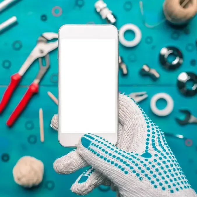Person holding up a phone that they are attempting to hack into