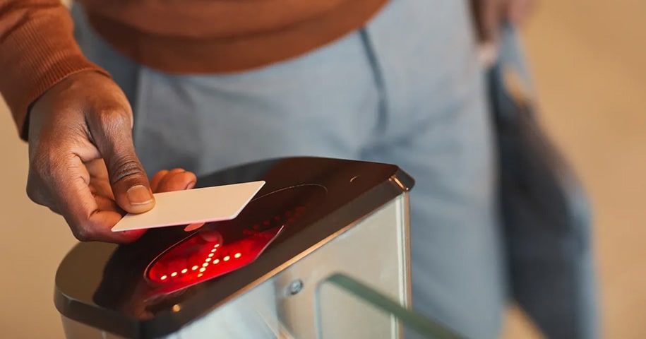 Person scanning their card on a machine to gain entry